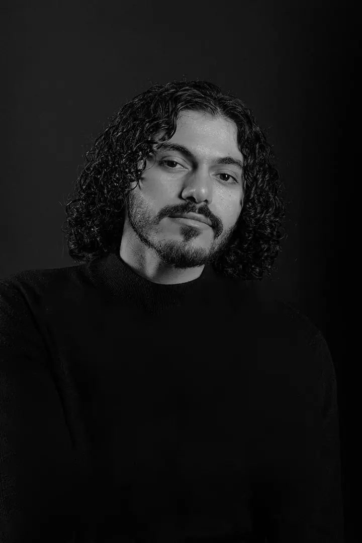Black and white portrait of SOUL, head tilted, in a black turtleneck