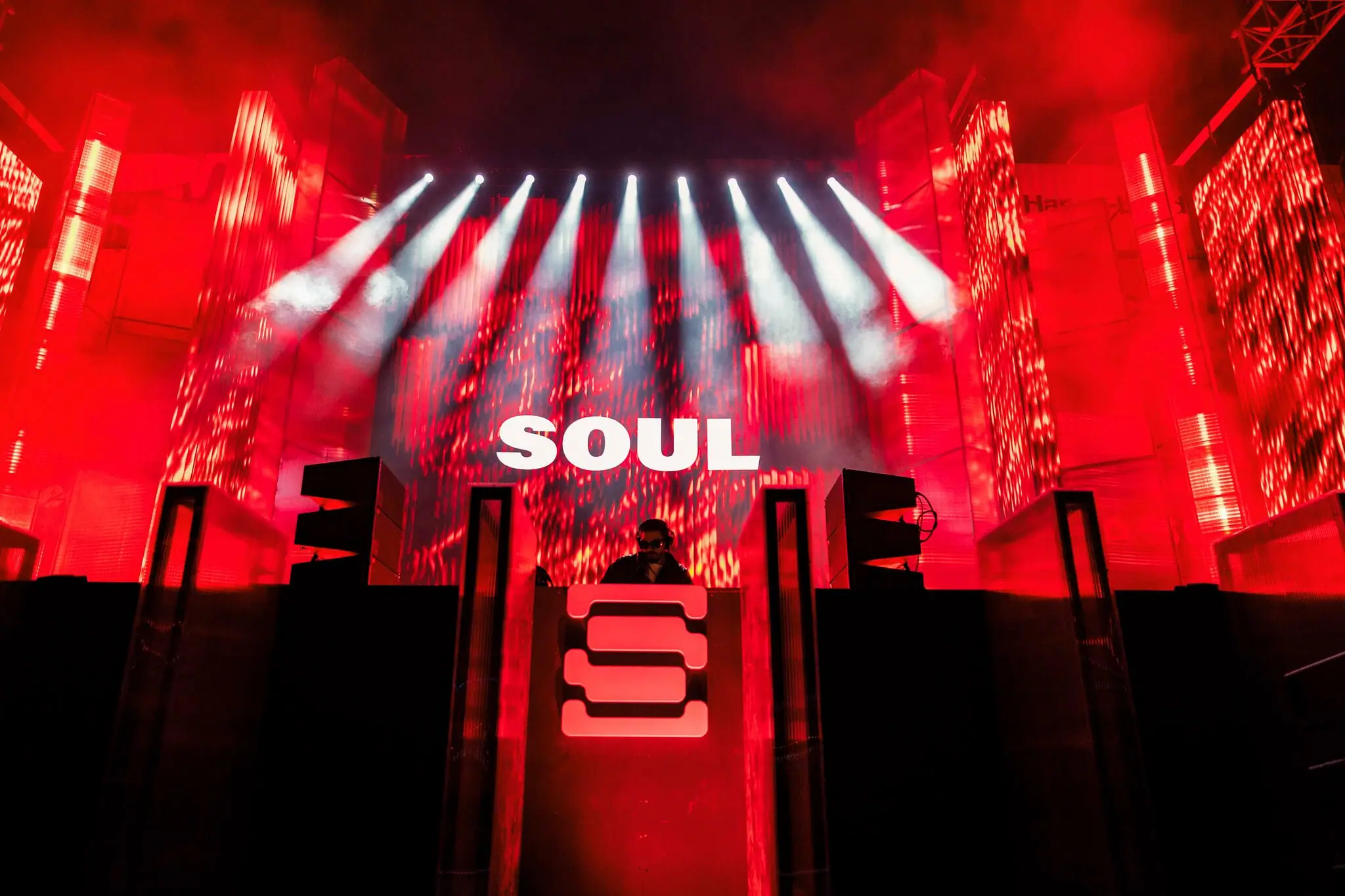 SOUL at the booth, his name on the stage screen above him